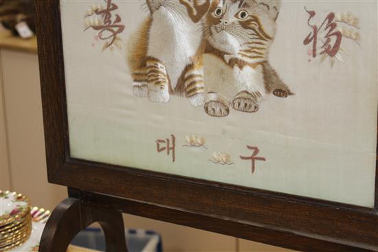An early 20th century Japanese silkwork panel of two kittens, mounted as an oak firescreen, panel 40 x 43cm